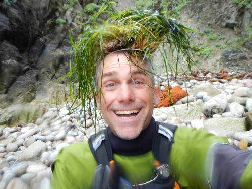 Smiling man with seaweed on his head/
